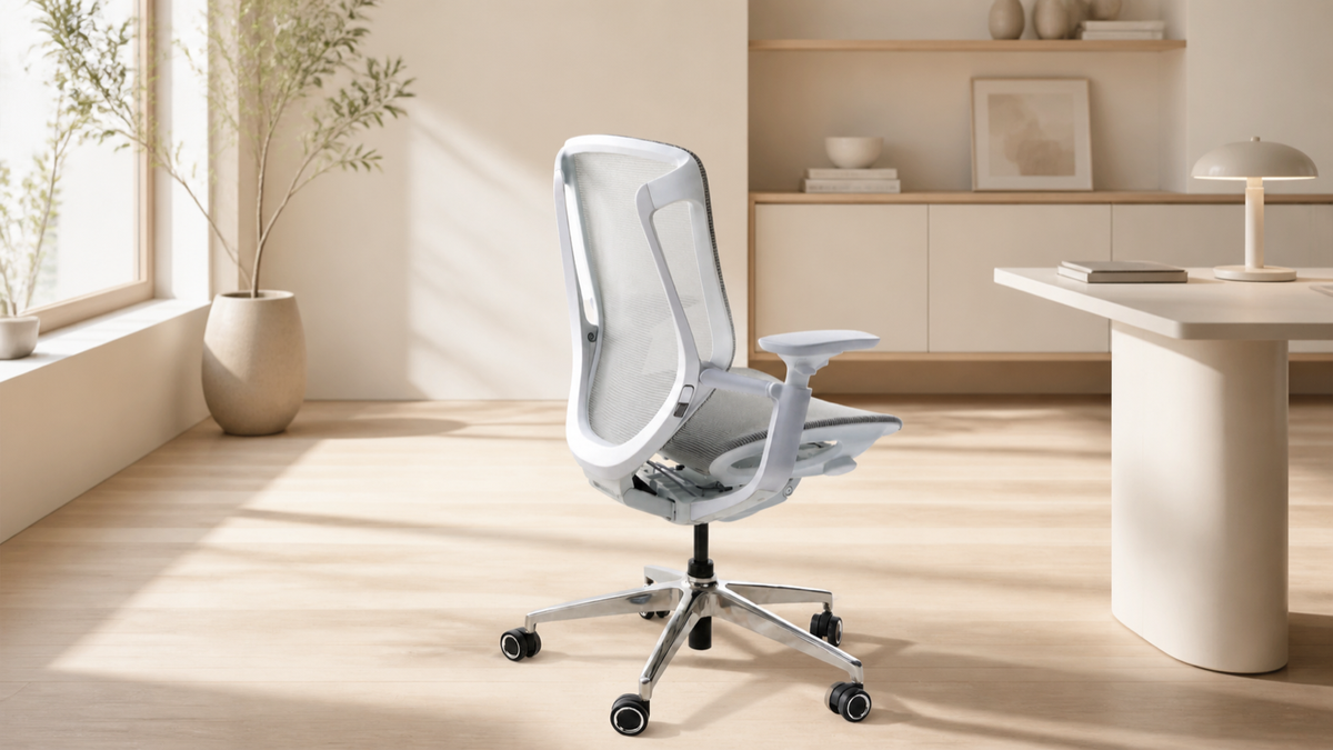 White BIRCH ergonomic chair in a warm home office, viewed from the rear three-quarter angle
