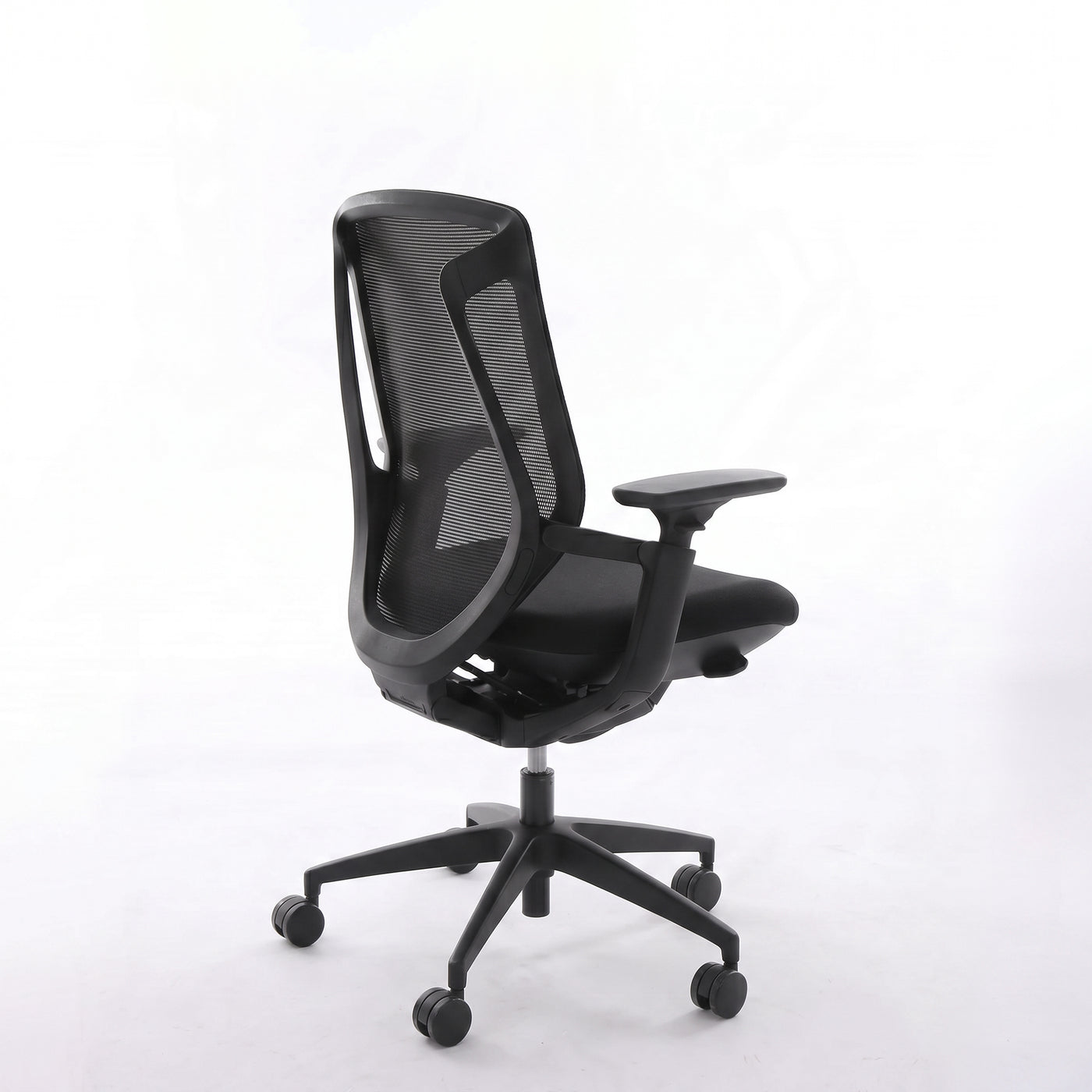 Black BIRCH ergonomic chair in rear three-quarter view showing its mesh back and five-wheel base