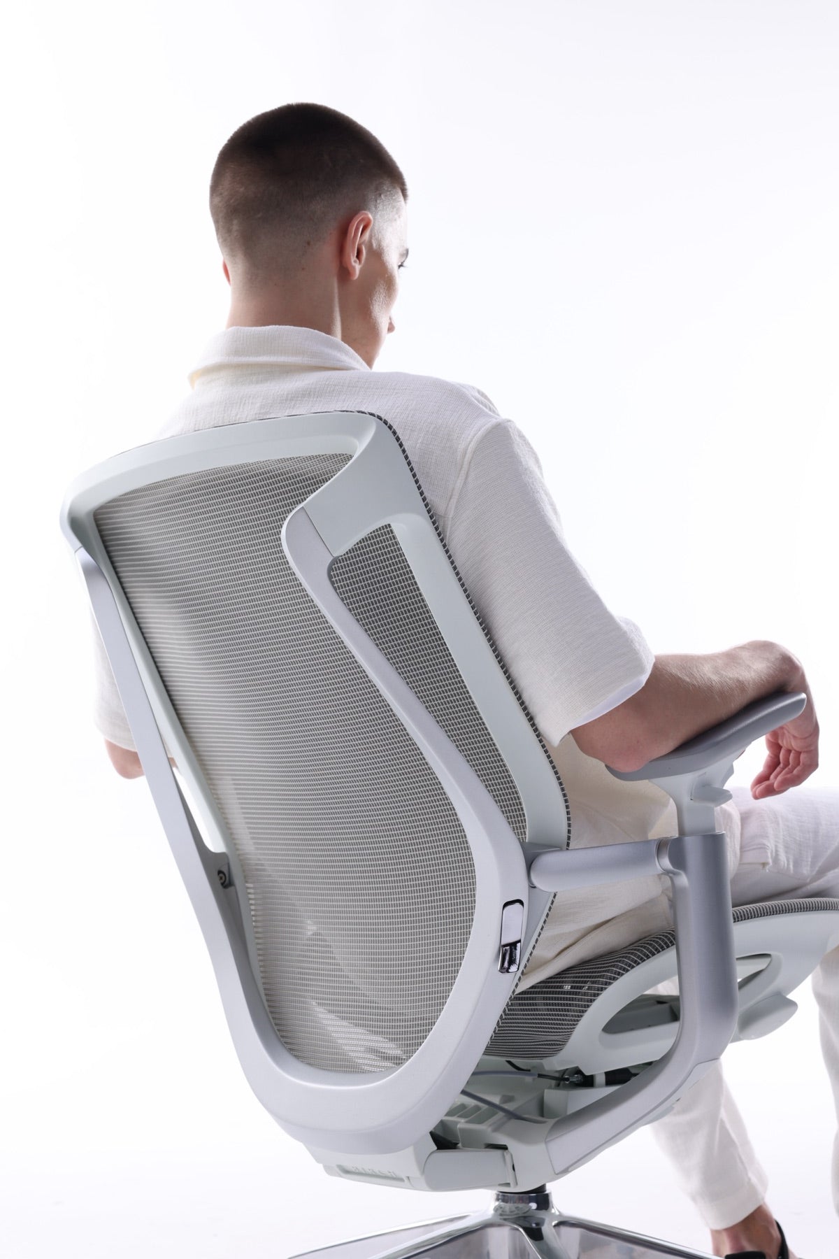 A seated person demonstrating how the BIRCH back moves